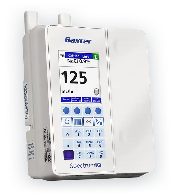 A medical infusion pump with a digital display showing Critical Care NaCl 0.9% and 125 mL/hr. The device has several buttons, a screen, and visible antennae on top. The brand name Baxter and model Spectrum IQ are printed on the device.